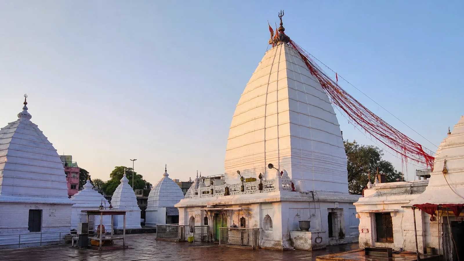 Baba Baidyanath Jyotirlinga Temple at Deoghar, with its white shikhara and red sacred threads in the temple courtyard.