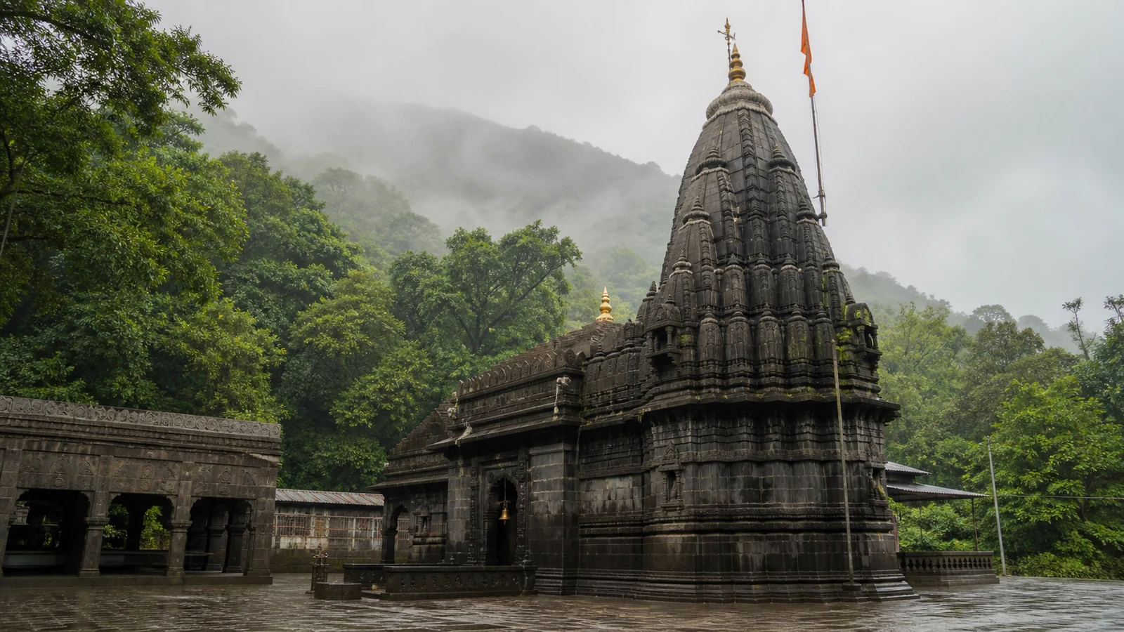 Bhimashankar Jyotirlinga Temple in Maharashtra, a dark stone shrine surrounded by misty Sahyadri forest.