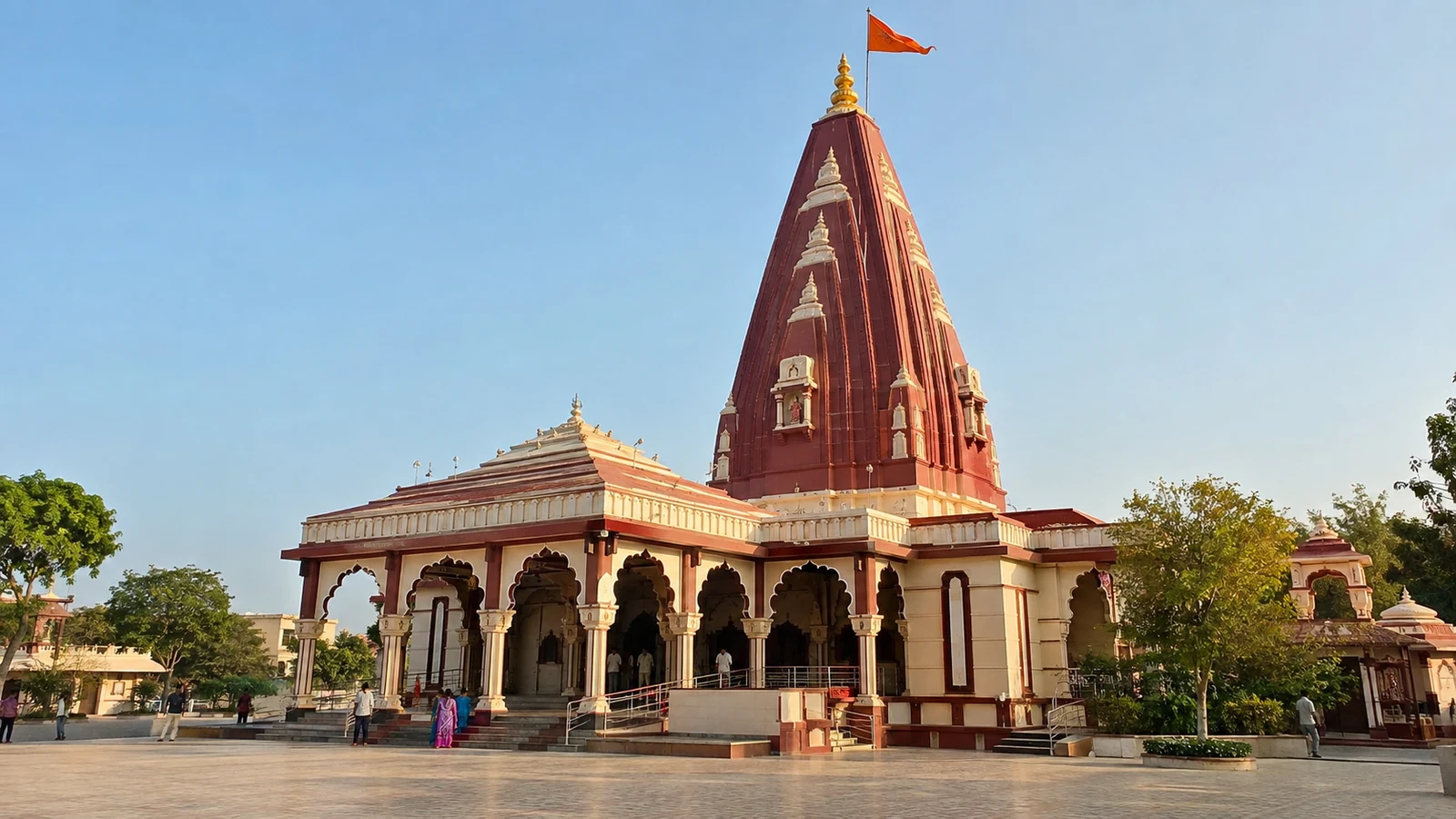 Present-day Nageshwar Jyotirlinga Temple near Dwarka, with its red shikhara, cream entrance arches and saffron flag.