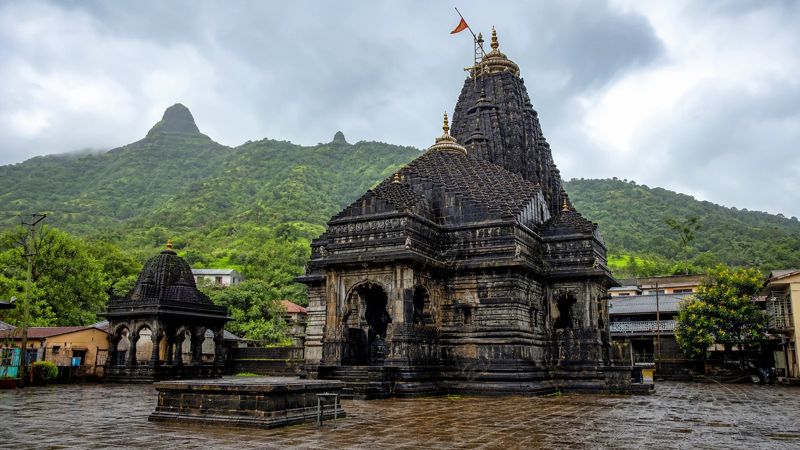 Trimbakeshwar Jyotirlinga Temple near Nashik, a black stone Shiva temple with Brahmagiri Hill behind.